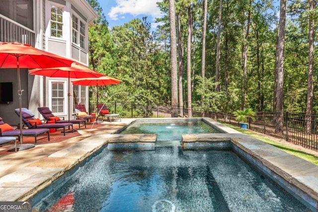 view of pool featuring a patio and an in ground hot tub