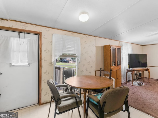 carpeted dining room featuring plenty of natural light