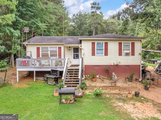 view of front of house with a wooden deck and a front yard