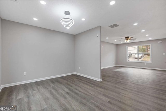 unfurnished room with dark hardwood / wood-style floors and ceiling fan