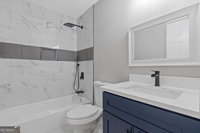 full bathroom featuring tiled shower / bath, vanity, and toilet