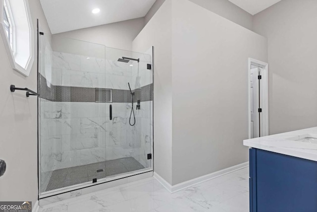 bathroom with vanity, vaulted ceiling, and a shower with door