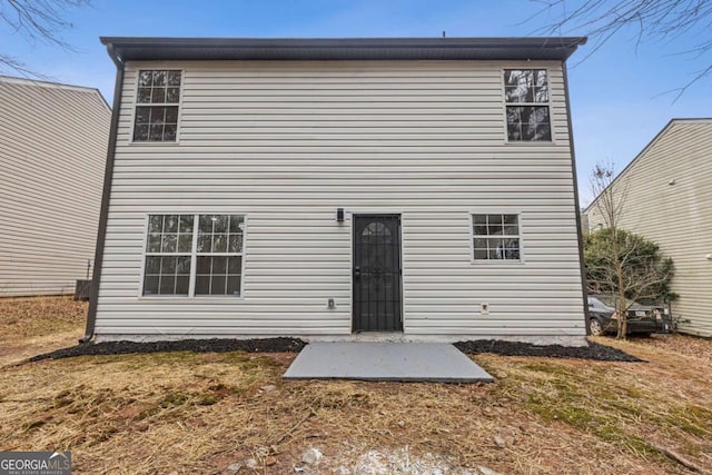 back of house featuring a yard and a patio area