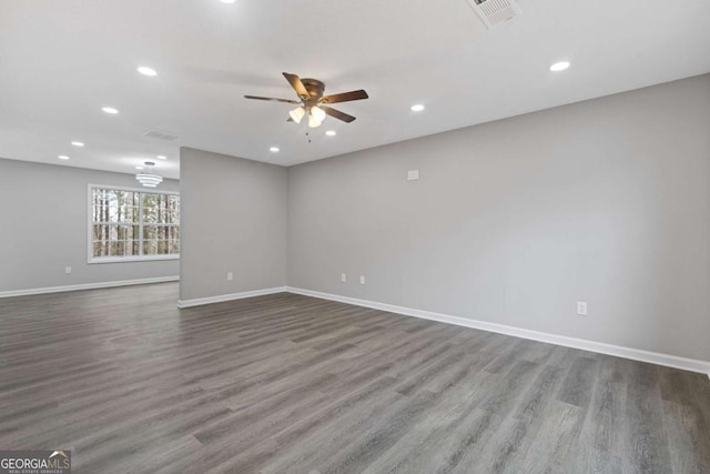 empty room with ceiling fan and hardwood / wood-style floors