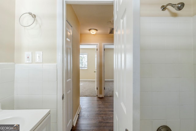 bathroom with vanity, hardwood / wood-style floors, and tile walls