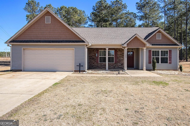 view of front of home featuring driveway, an attached garage, a front lawn, and roof with shingles