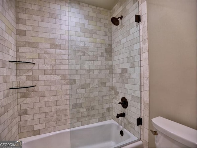 bathroom featuring toilet and tiled shower / bath combo