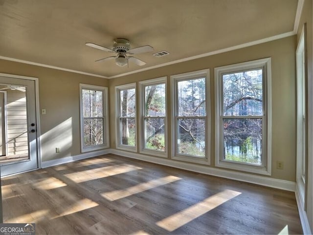 unfurnished sunroom with ceiling fan