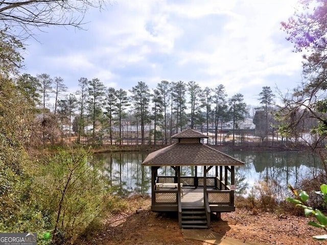 view of dock featuring a gazebo and a water view