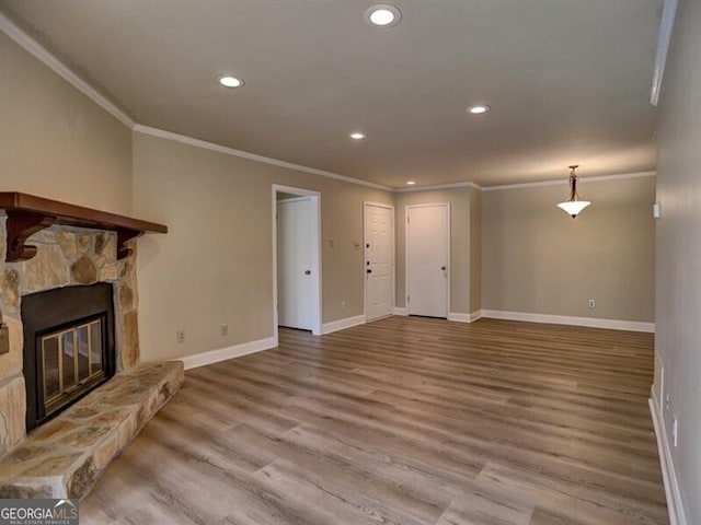 unfurnished living room with crown molding, hardwood / wood-style floors, and a fireplace