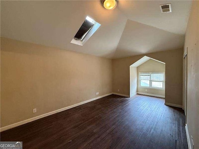 additional living space featuring lofted ceiling and dark hardwood / wood-style floors