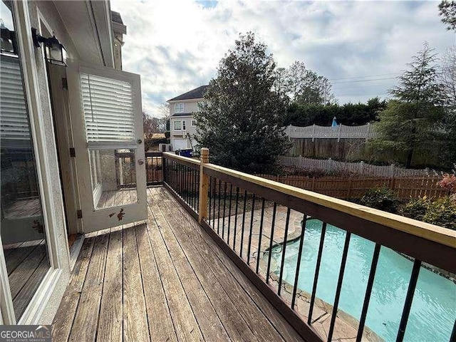 wooden terrace featuring a pool