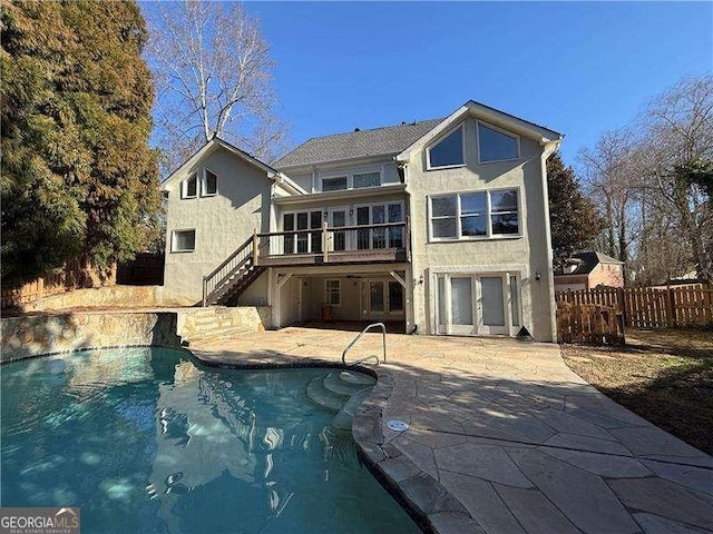 back of property with a patio area and a swimming pool side deck