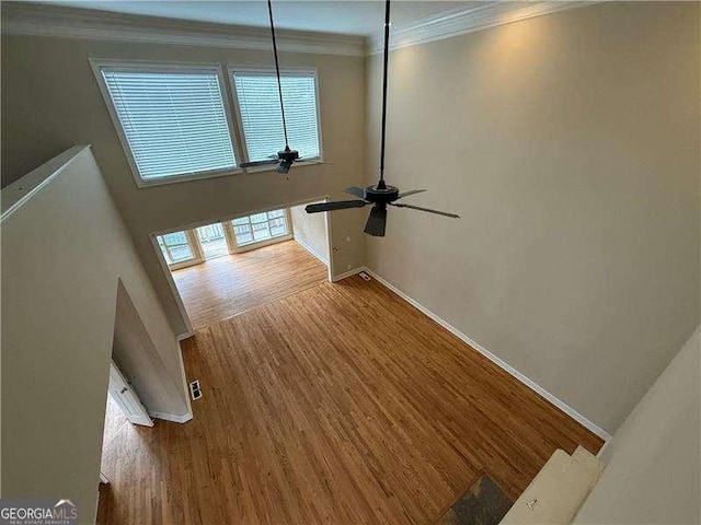 interior space with crown molding, ceiling fan, and hardwood / wood-style floors