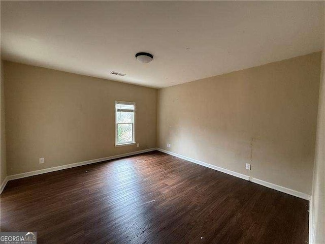 empty room featuring dark wood-type flooring