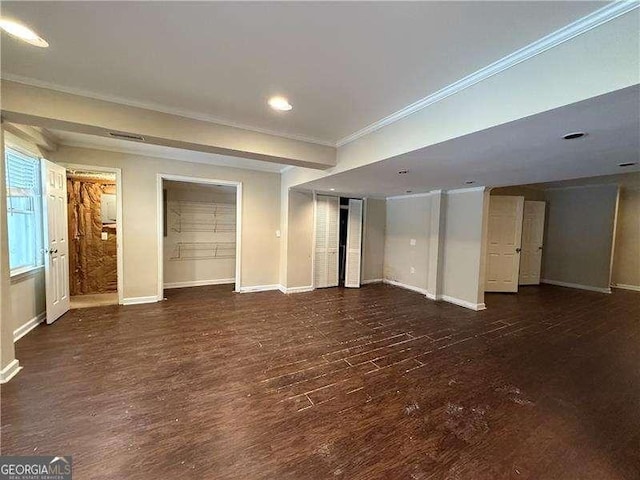 interior space with ornamental molding and dark hardwood / wood-style flooring