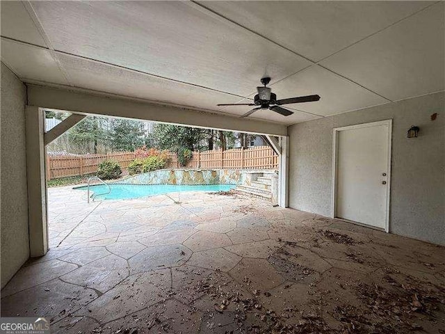 view of pool with a patio and ceiling fan