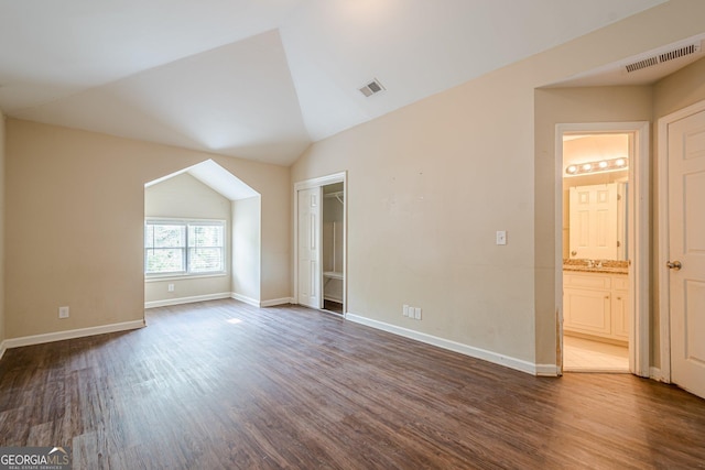 interior space with visible vents, baseboards, and dark wood-style floors