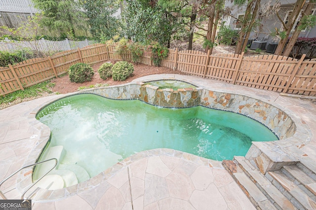 view of pool featuring a patio area, a fenced backyard, an in ground hot tub, and a fenced in pool