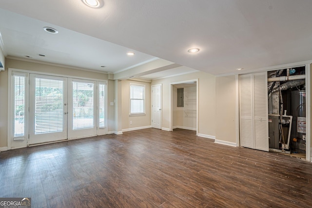 unfurnished living room featuring ornamental molding, electric panel, water heater, baseboards, and dark wood-style floors