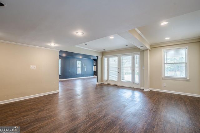 unfurnished living room with ornamental molding, baseboards, recessed lighting, and dark wood-style floors