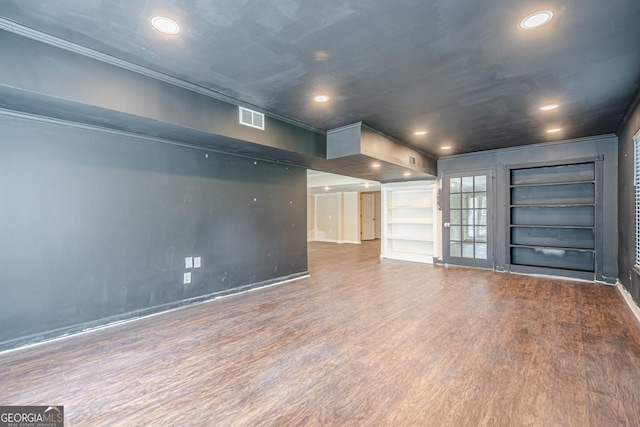 interior space with built in features, baseboards, visible vents, recessed lighting, and wood finished floors