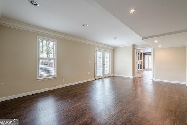 unfurnished room featuring ornamental molding, plenty of natural light, and dark wood finished floors