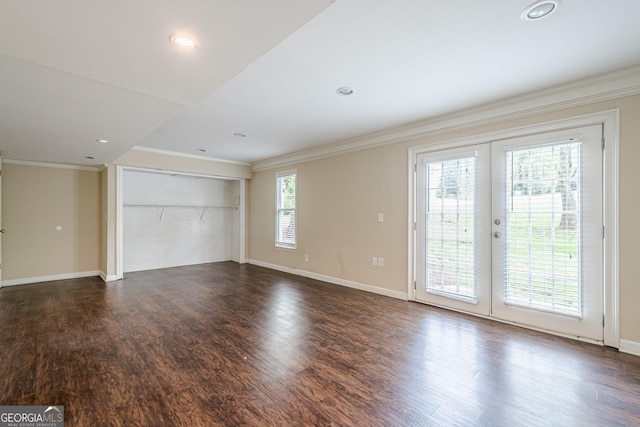 unfurnished living room with baseboards, ornamental molding, recessed lighting, french doors, and dark wood-type flooring