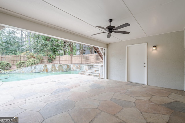 view of patio featuring a fenced in pool, ceiling fan, a fenced backyard, and stairway