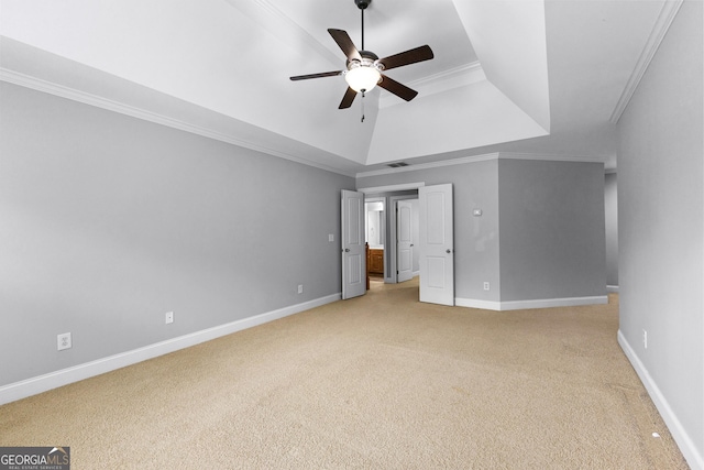 unfurnished bedroom featuring light carpet, baseboards, visible vents, ornamental molding, and a tray ceiling