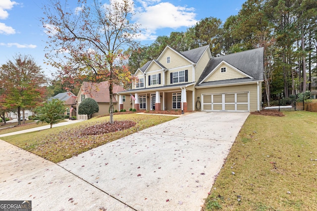 traditional-style house with a porch, an attached garage, fence, concrete driveway, and a front yard