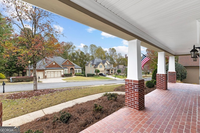 view of patio / terrace featuring a porch and a residential view