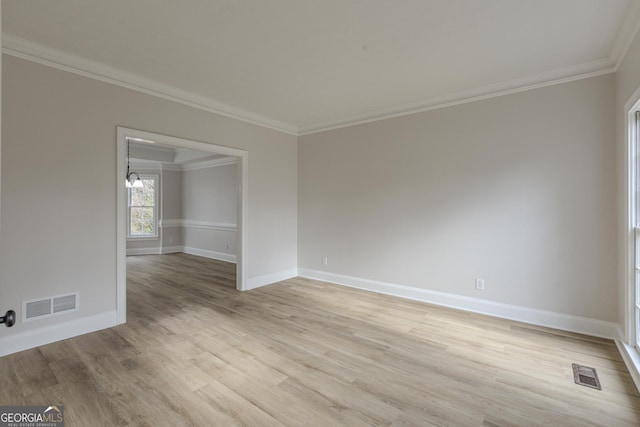 spare room with light hardwood / wood-style flooring and ornamental molding