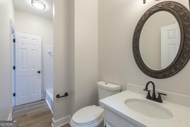 bathroom featuring hardwood / wood-style flooring, vanity, and toilet