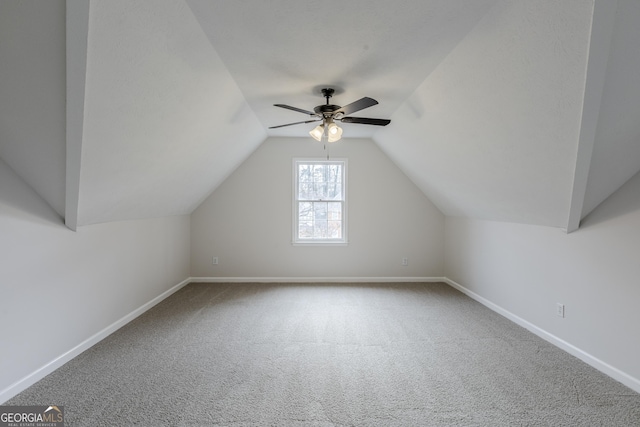 bonus room featuring lofted ceiling, carpet flooring, and ceiling fan