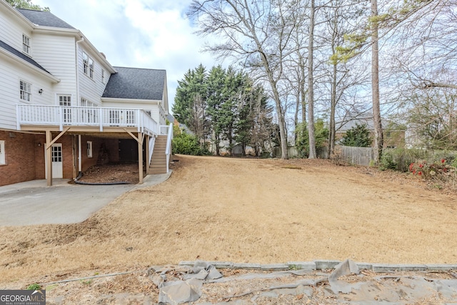 view of yard featuring a wooden deck and a patio area