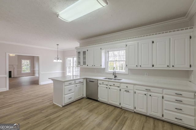 kitchen with sink, white cabinetry, decorative light fixtures, kitchen peninsula, and dishwasher