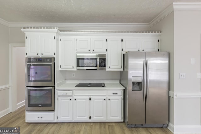 kitchen featuring crown molding, white cabinetry, stainless steel appliances, a textured ceiling, and light wood-type flooring