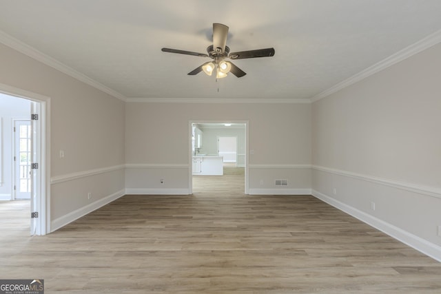 unfurnished room featuring crown molding, ceiling fan, and light wood-type flooring