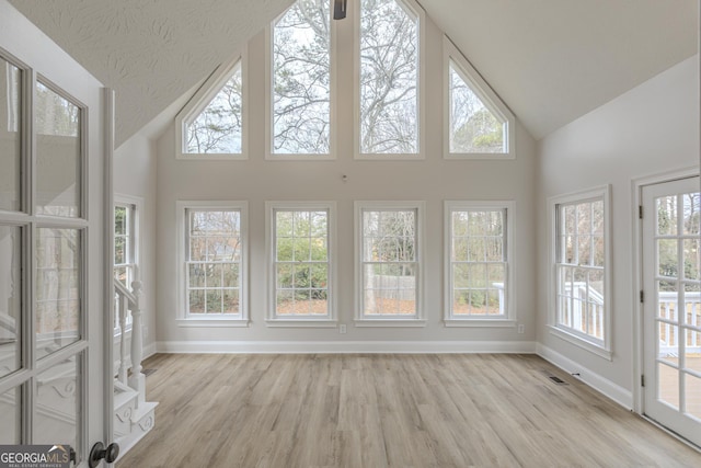 unfurnished sunroom with vaulted ceiling and a healthy amount of sunlight