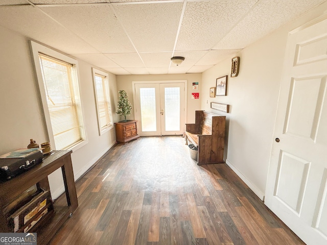 entryway with a drop ceiling, dark hardwood / wood-style flooring, and french doors