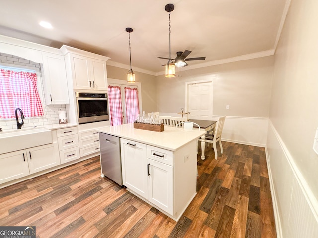 kitchen featuring a kitchen island, appliances with stainless steel finishes, white cabinetry, sink, and dark hardwood / wood-style flooring