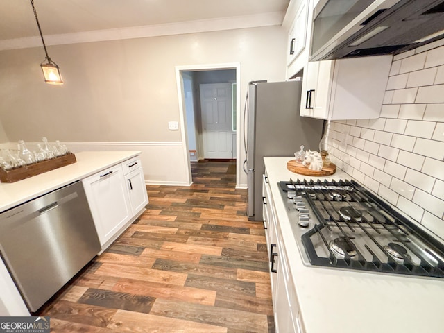 kitchen featuring pendant lighting, dishwasher, gas stovetop, ornamental molding, and white cabinets