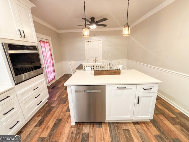 kitchen featuring white cabinetry, appliances with stainless steel finishes, a kitchen island with sink, and crown molding