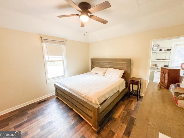 bedroom with dark wood-type flooring and ceiling fan