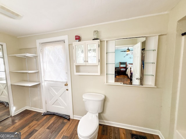 bathroom with hardwood / wood-style floors and toilet