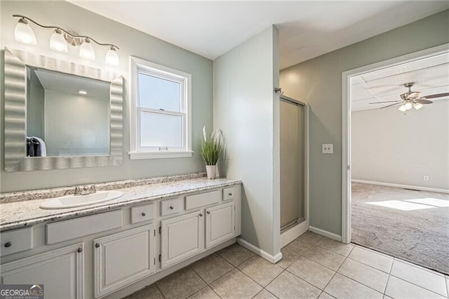 bathroom with vanity, tile patterned floors, ceiling fan, and walk in shower