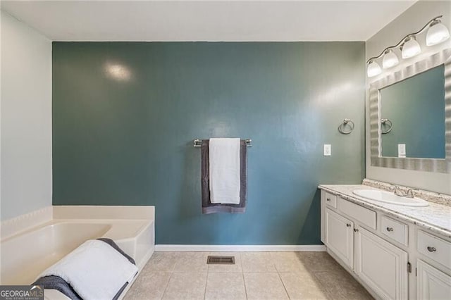 bathroom with vanity, tile patterned flooring, and a bathing tub