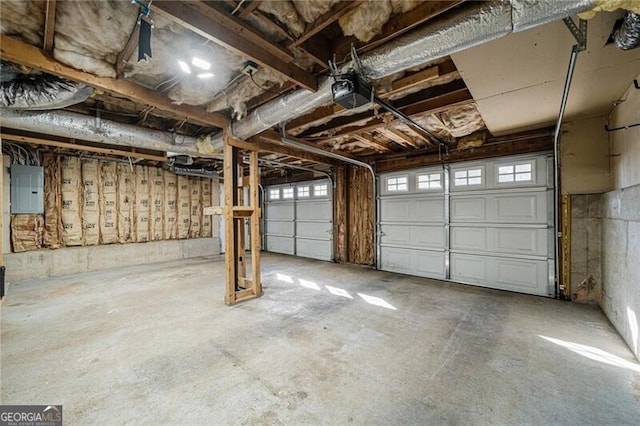 garage with a garage door opener and electric panel