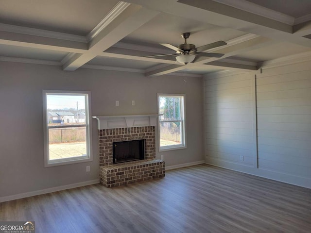 unfurnished living room with crown molding, a fireplace, wood-type flooring, and coffered ceiling